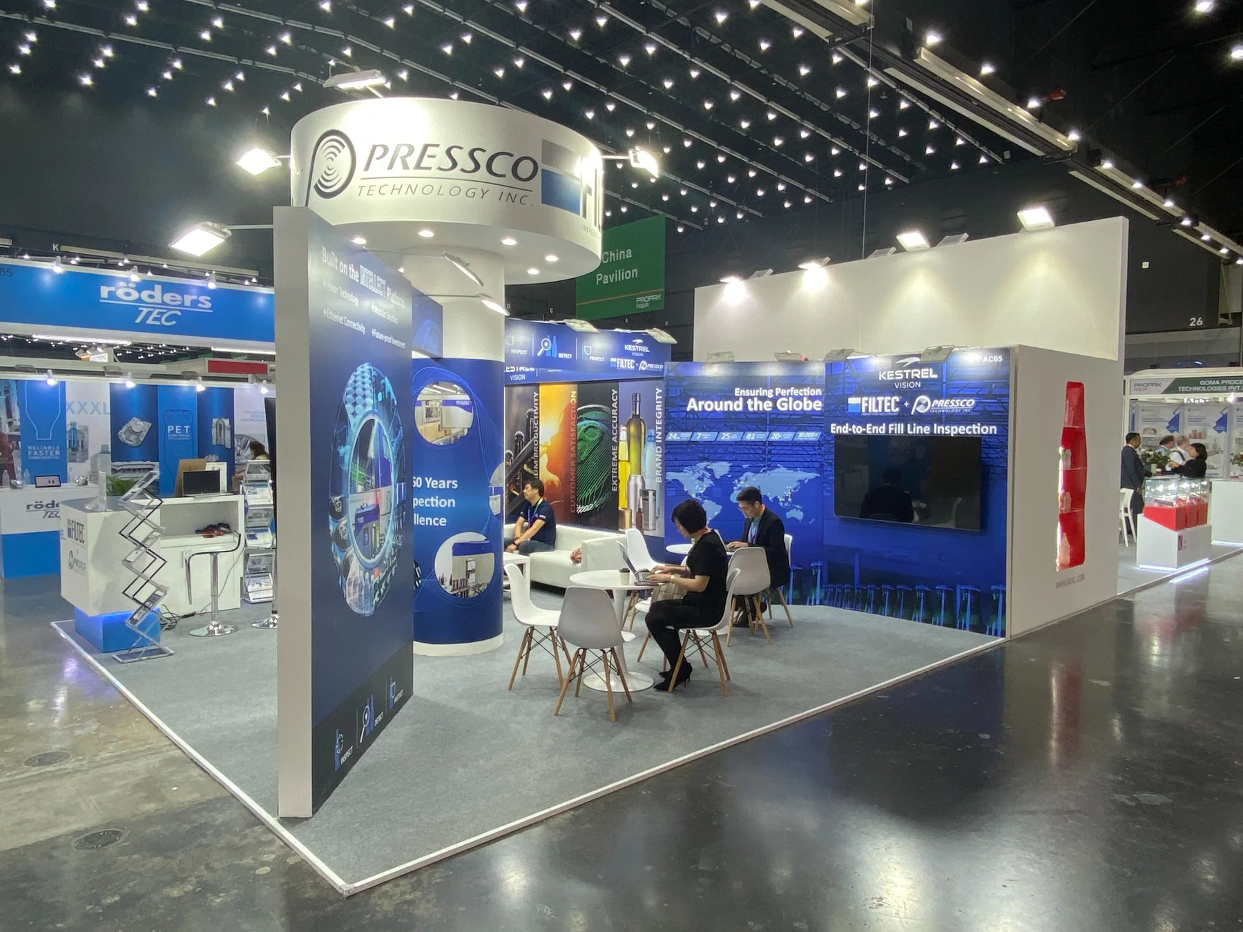 Completed FILTEC booth showing meeting spaces and technical graphic walls